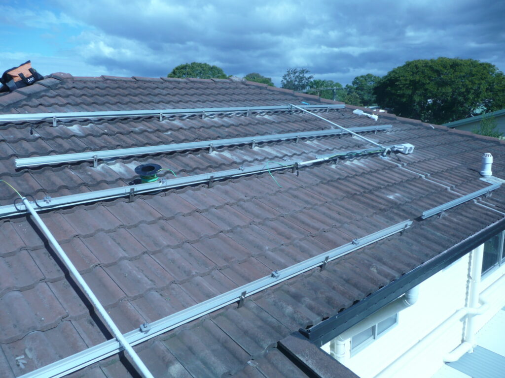 The Tile Roof PV System is a specialized solar energy solution designed to harness the power of the sun and convert it into clean, renewable electricity. This system is specifically engineered to be installed on tile roofs, which are common in many regions, including Queensland, Australia.

The primary purpose of the Tile Roof PV System is to generate electricity for residential, commercial, or industrial applications. By utilizing photovoltaic panels mounted on tile roofs, this system can produce a significant amount of energy, up to 300 kW in some cases, depending on the size and configuration.

One of the key features of the Tile Roof PV System is its use of adjustable-foot bracket systems, which provide stability and flexibility. These brackets are often made from durable materials like aluminum alloy, ensuring they can withstand harsh weather conditions and last for many years.

The system also incorporates a HOOK fixing method, which is particularly effective for attaching panels to glazed tile roofs. This method ensures a secure and reliable connection, maximizing energy production while minimizing the risk of damage to the roof.

By installing a Tile Roof PV System, property owners can benefit from reduced energy bills, lower carbon emissions, and increased property value. Additionally, this system can help to mitigate the impact of local climate conditions, such as high temperatures and intense sunlight, by providing shade and reducing heat absorption.

Overall, the Tile Roof PV System is a versatile and efficient solution for generating clean energy on tile roofs. Its combination of innovative design features and durable materials makes it an attractive option for anyone interested in investing in renewable energy.